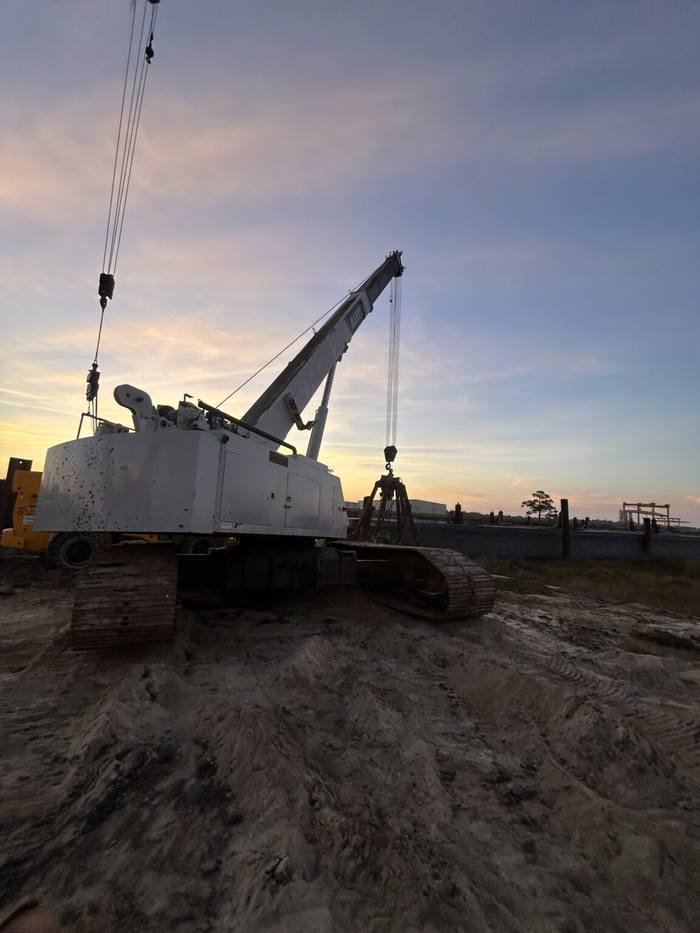 Crawler crane on the job site at sunset