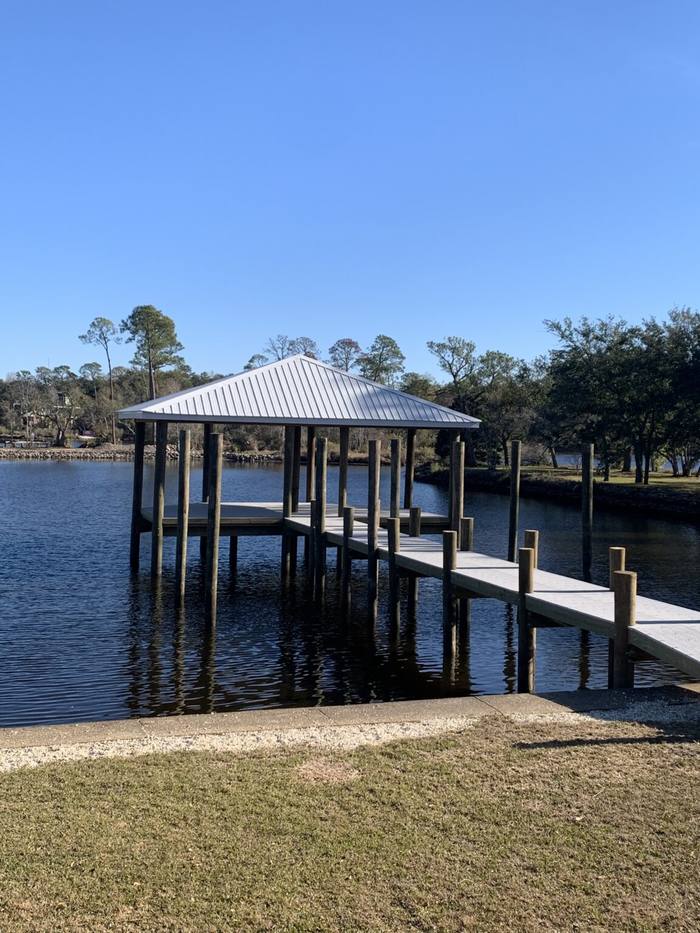 Pier with a covered end platform on calm water