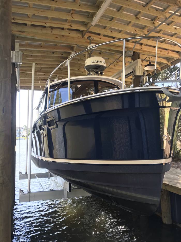 Ranger Tug raised on a Deco lift inside the boathouse