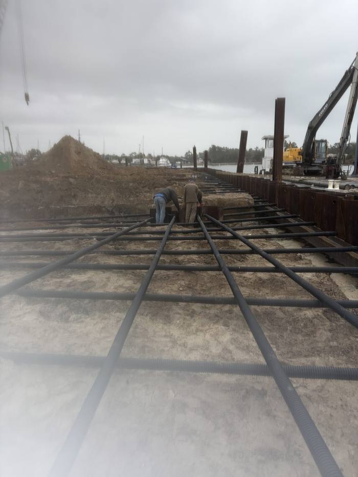 Grid of steel tiebacks laid out behind the new sheet pile wall